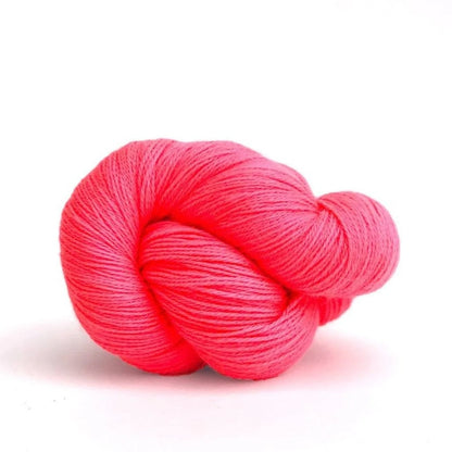 Neon pink skein of yarn on a white background