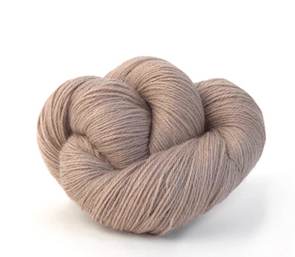 beige skein of yarn on white background
